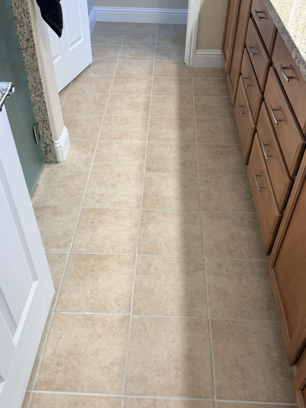 Completed ceramic bathroom floor with lighter grout