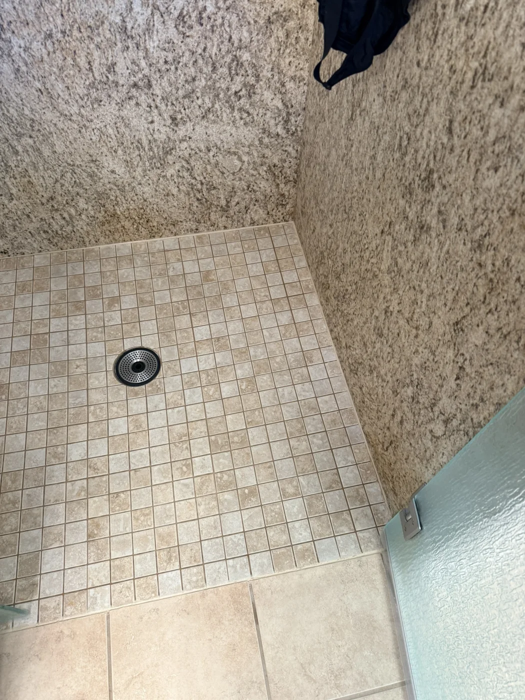 Completed mosaic shower pan with the perimeter tape removed